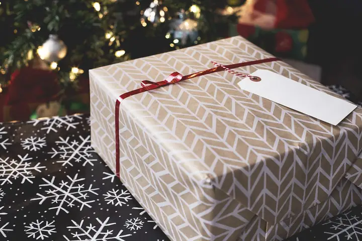 A wrapped Christmas gift with a blank gift tag