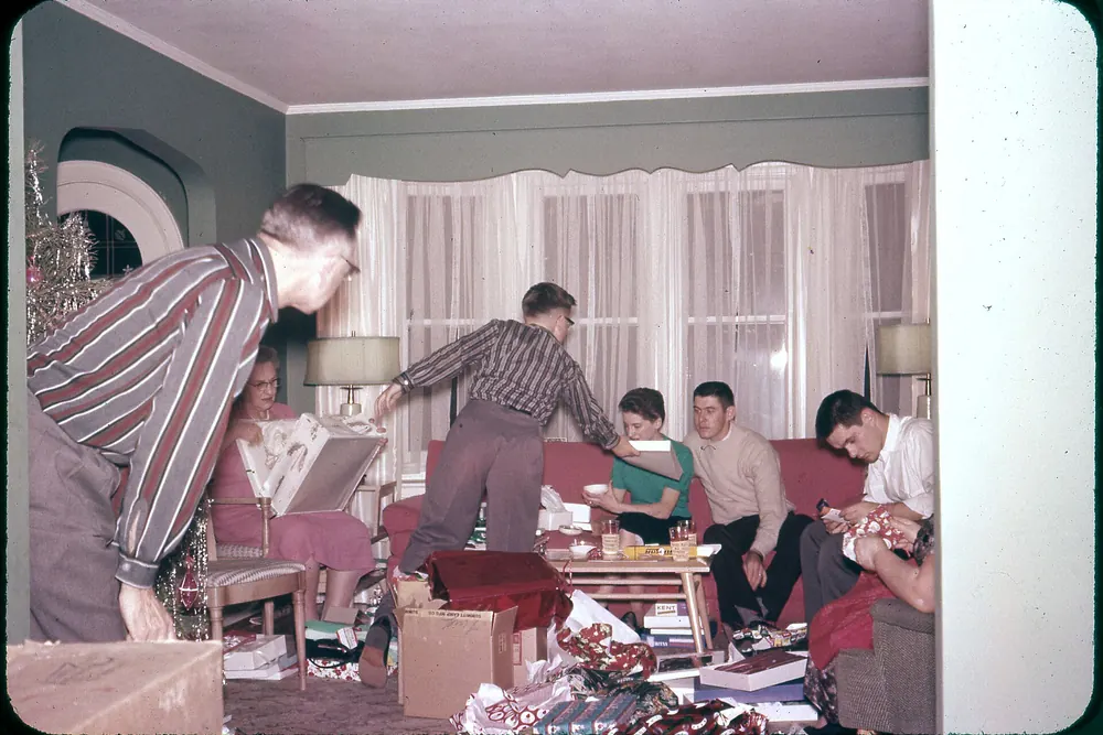 The Mosbacher family opening Christmas presents around a tree